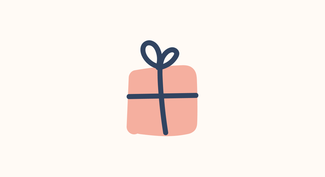 a pink wrapped present with a dark blue ribbon