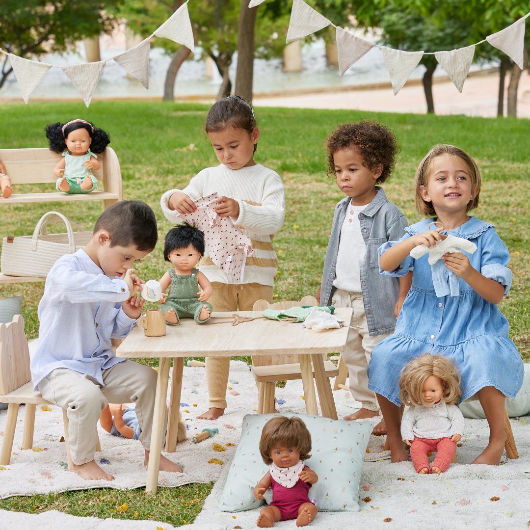 Miniland Dolls Collection page image, kids playing with inclusive dolls