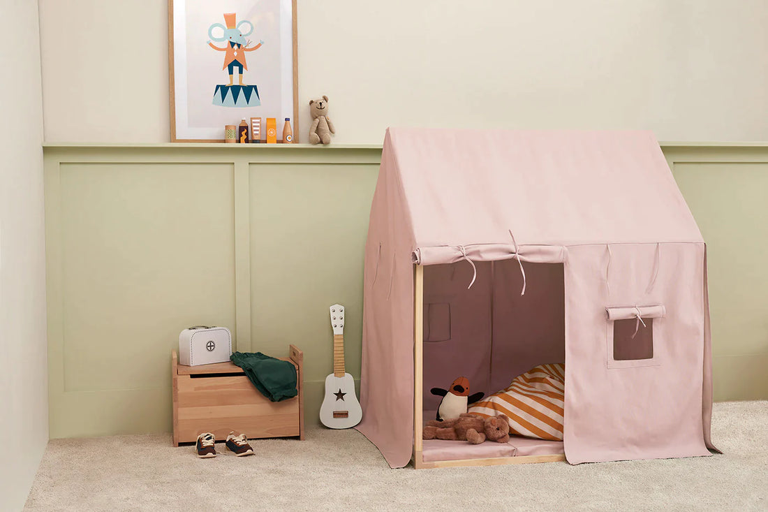 children's room with a pink tent, a white guitar and a wooden toy chest.