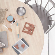 Kids Concept Wooden Toy Baking Set with animal-shaped cookie cutters, scale, rolling pin, and baking sheet on a wooden table, perfect for creative play and early childhood development. 
