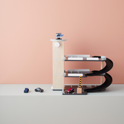 Kids Concept Wooden Toy Garage with three levels, a helipad, and includes three cars and one helicopter. 