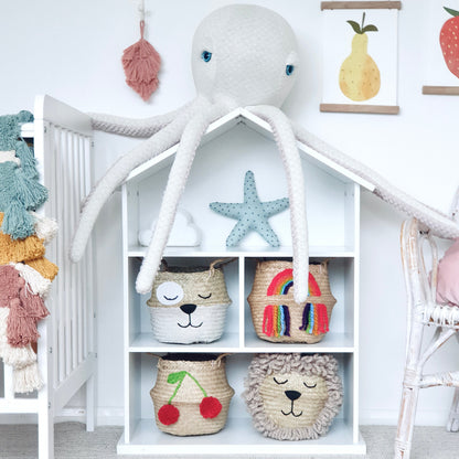 Children's room with white bookshelf, colorful baskets, and decorative items.