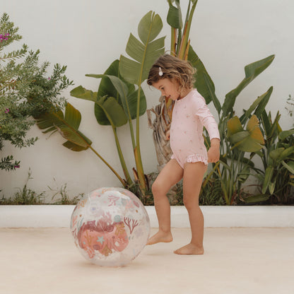 Child kicking Little Dutch 3D beach ball in pink