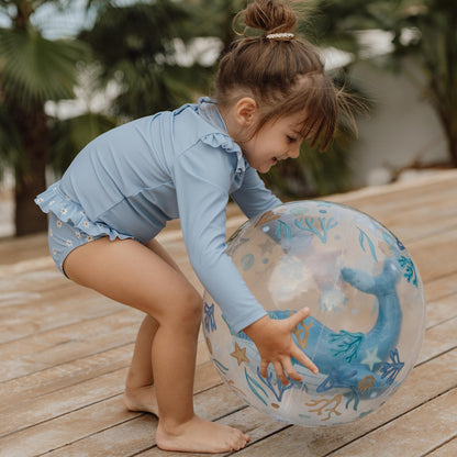Child picking up Little Dutch 3D Beach Ball in blue
