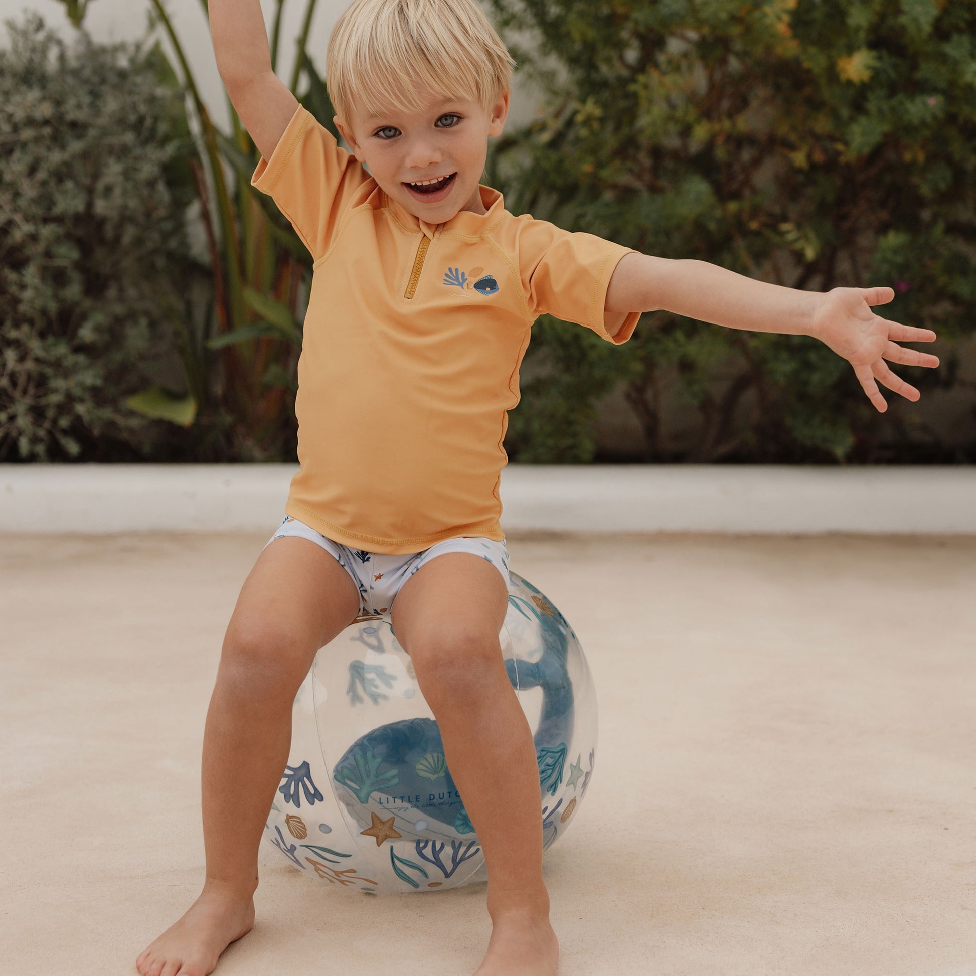 Child sitting on Little Dutch 3D Beach Ball in blue
