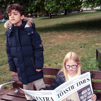 Two children wearing navy blue puffer parka coats