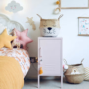 Children's room with a bed, storage cabinet, and decorative items.
