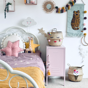 Children's bedroom with a bed, nightstand, and decorative items.