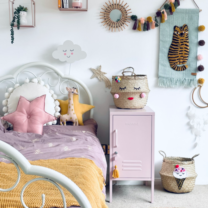 Children's bedroom with a bed, nightstand, and decorative items.