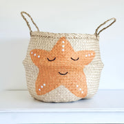 Woven basket with a starfish design on a white background