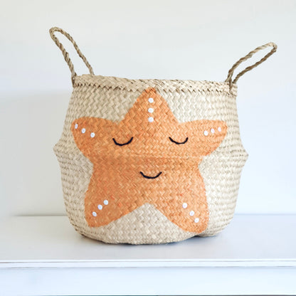 Woven basket with a starfish design on a white background