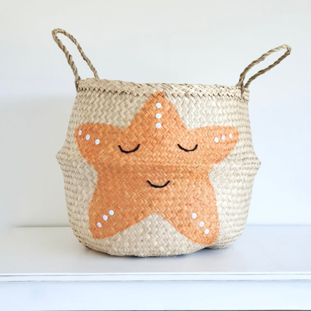 Woven basket with a starfish design on a white background