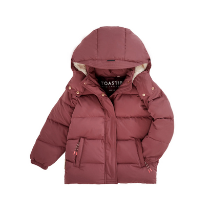 A dusty rose puffer jacket with a hood, featuring a soft cream-colored fleece lining visible inside the hood and collar, and the brand name 'TOASTIE' printed on the inner neck label.