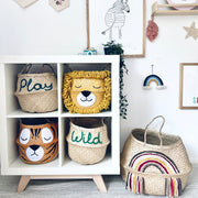 Children's room with decorative baskets, wall art, and toys.