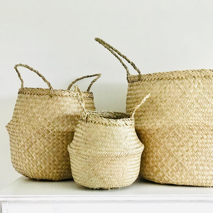 Three woven baskets of different sizes on a white surface with a white background