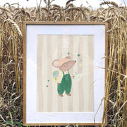 Framed illustration of a mouse in overalls standing in a field of wheat.