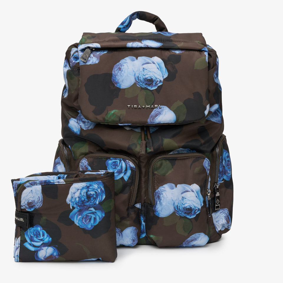 A dark brown backpack with a blue rose floral print and a matching zippered pouch, displayed on a clean white background.