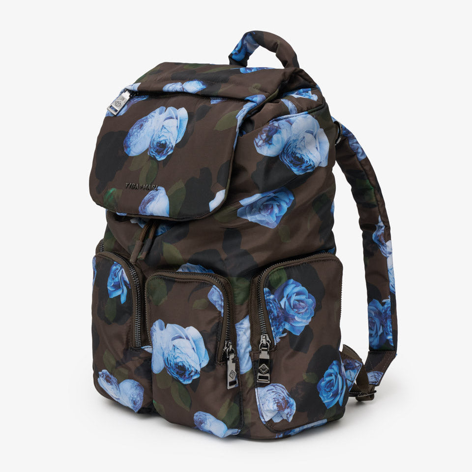 A dark brown backpack featuring a blue rose pattern, shown against a plain light gray background.