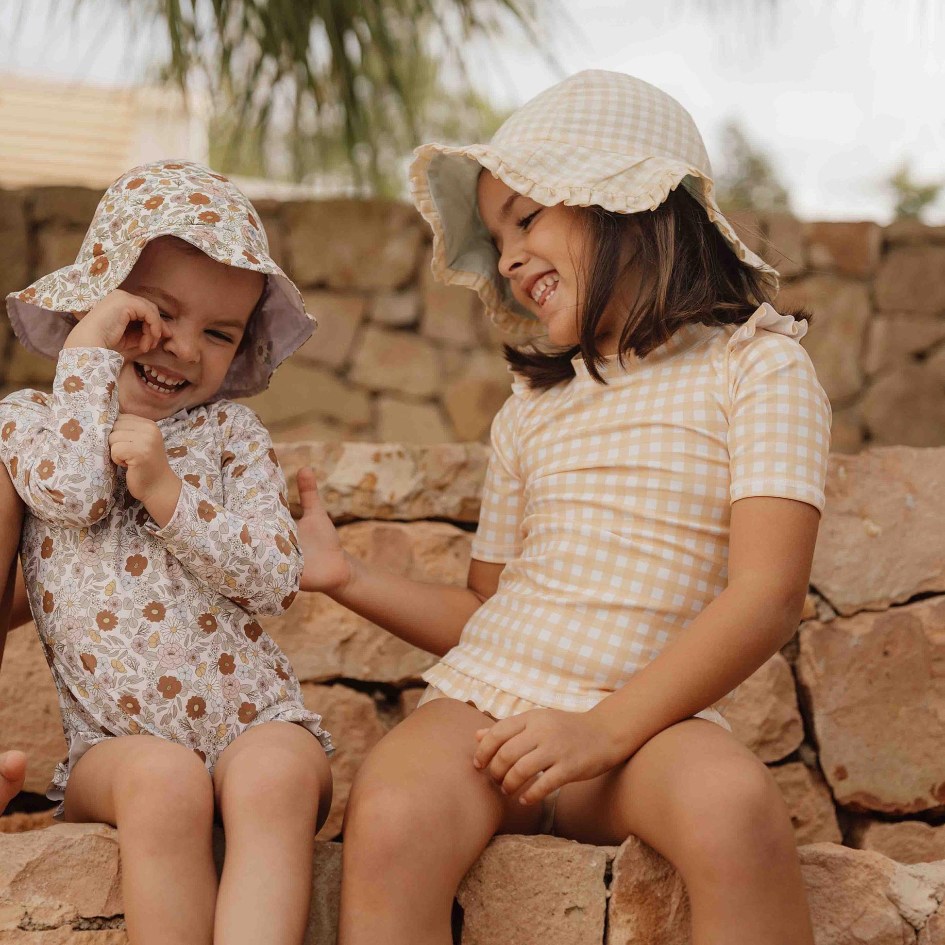 Little girl wearing Little Dutch Reversible Sun Hat In Sunshine Check