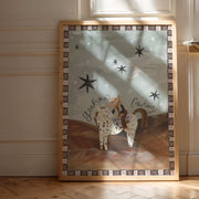 Framed artwork of a cowboy on a horse with stars, displayed on a wall.
