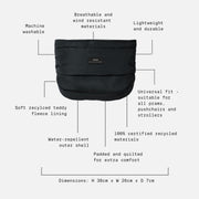 A black puffer-style pram insert or insert pouch shown on a white background with dotted lines and text callouts describing features such as machine washability, breathable and wind-resistant materials, lightweight durability, soft recycled teddy fleece lining, water-repellent outer shell, universal fit, and dimensions.