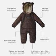 A Finnson baby puffer snowsuit with a brown and black leopard print pattern, featuring a plush cream fleece lining, a bear ear hood, and black trim. The image includes text callouts with dotted lines pointing to features like 'Lightweight and durable', 'Machine washable', 'Wind and water resistant', 'Breathable', 'Padded and quilted for extra comfort', and '0-12 months with feet, 12 months+ without feet'.