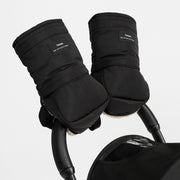 Black insulated stroller handwarmer sleeves with a small white 'frozen' brand patch, shown attached to a stroller handle against a light gray background.