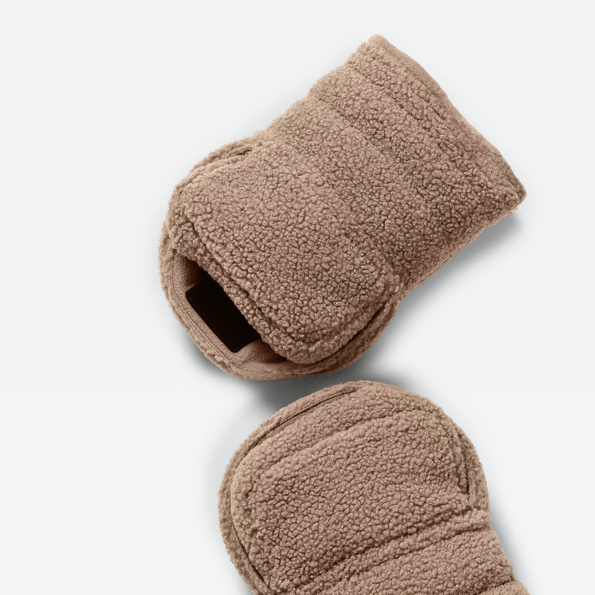 A pair of Finnson fleece-lined stroller mittens in a warm taupe-brown color, shown from a top-down angle on a clean white background.