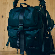 Finnson Black backpack attached to a stroller against a wooden background