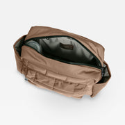 A Finnson mocha brown freya stroller organiser with an open top zipper, showing interior lining and a small interior brand label.
