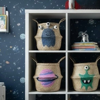 Children's room with shelves displaying wicker baskets with space themed designs against a space-themed wall.