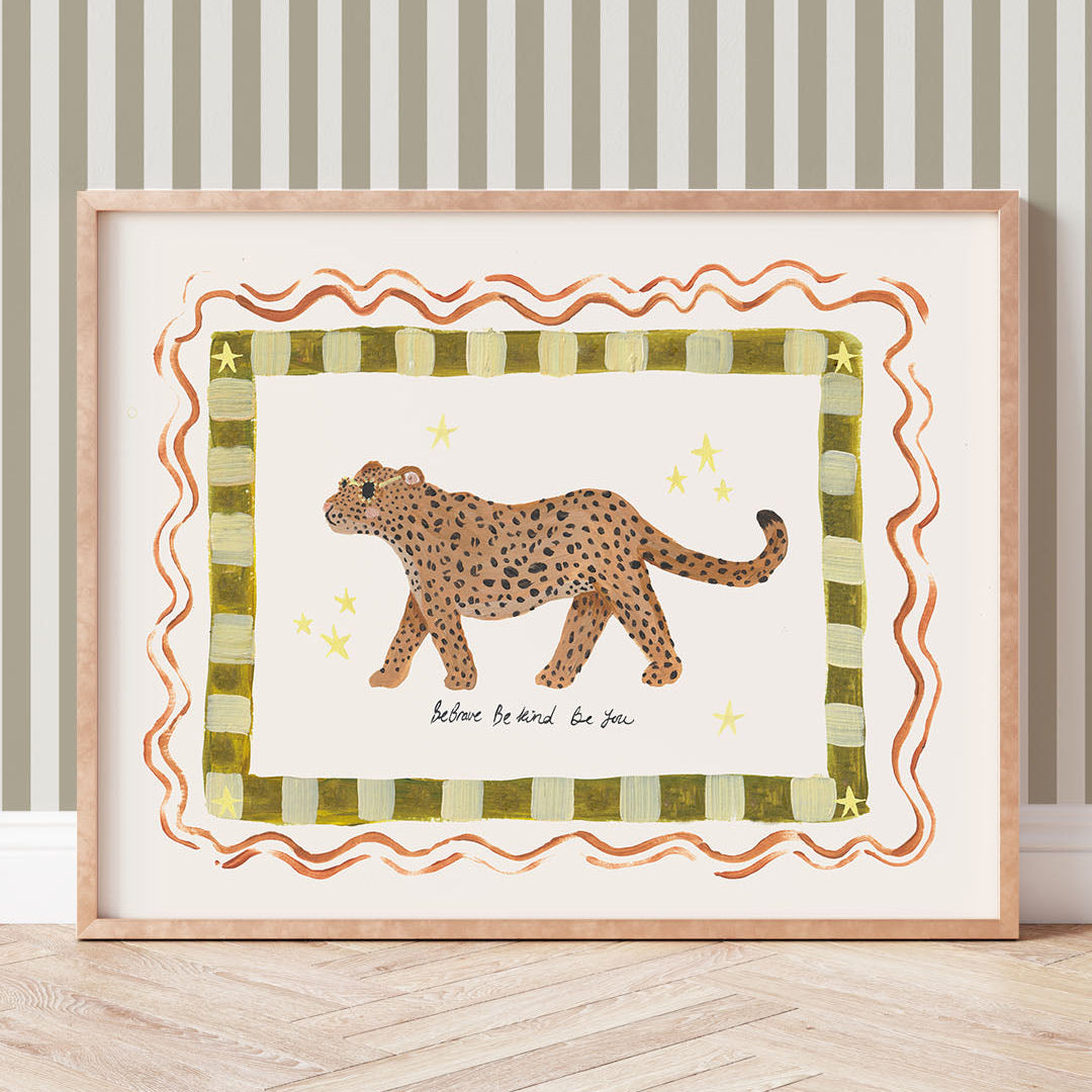 Framed artwork of a leopard on a striped background with the phrase 'Be brave, be kind, be you'