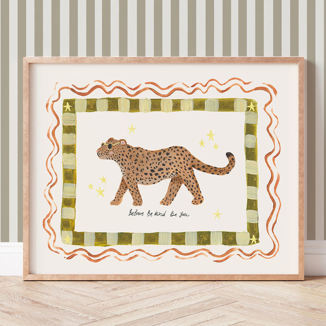 Framed artwork of a leopard on a striped background with the phrase 'Be brave, be kind, be you'