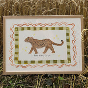 Framed artwork of a jaguar placed in a field of wheat