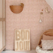 Wall with checkered pattern, decorative items, and 'Bonjour' sign in a room.