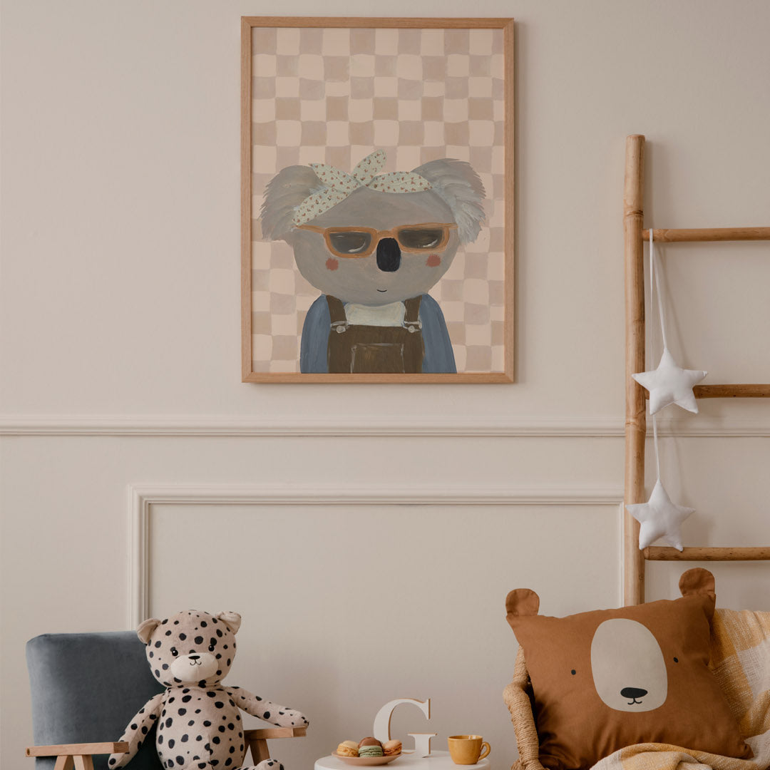 Children's room with a koala art print, plush toys, and a wicker chair.