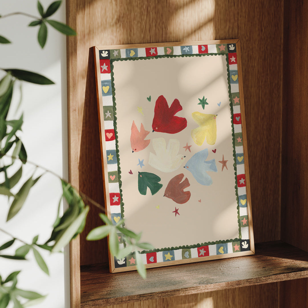 Framed artwork with colorful abstract design on a wooden shelf.