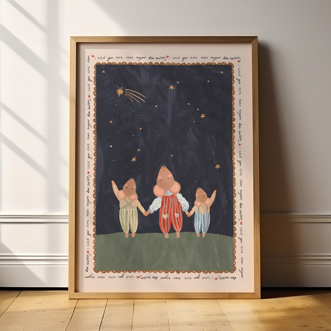 Framed artwork of three mice holding hands under a starry sky on a wall.