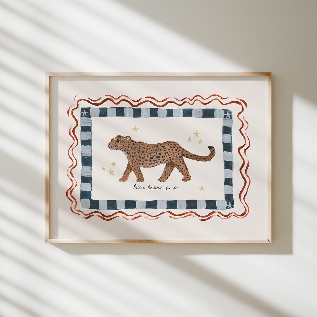 Framed artwork with a leopard illustration and the words 'be brave, be kind, be you'