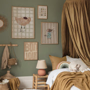 Children's bedroom with green walls, framed artwork, and a bed with brown bedding.