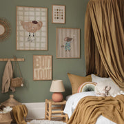 Children's bedroom with green walls, framed artwork, and a bed with brown bedding.