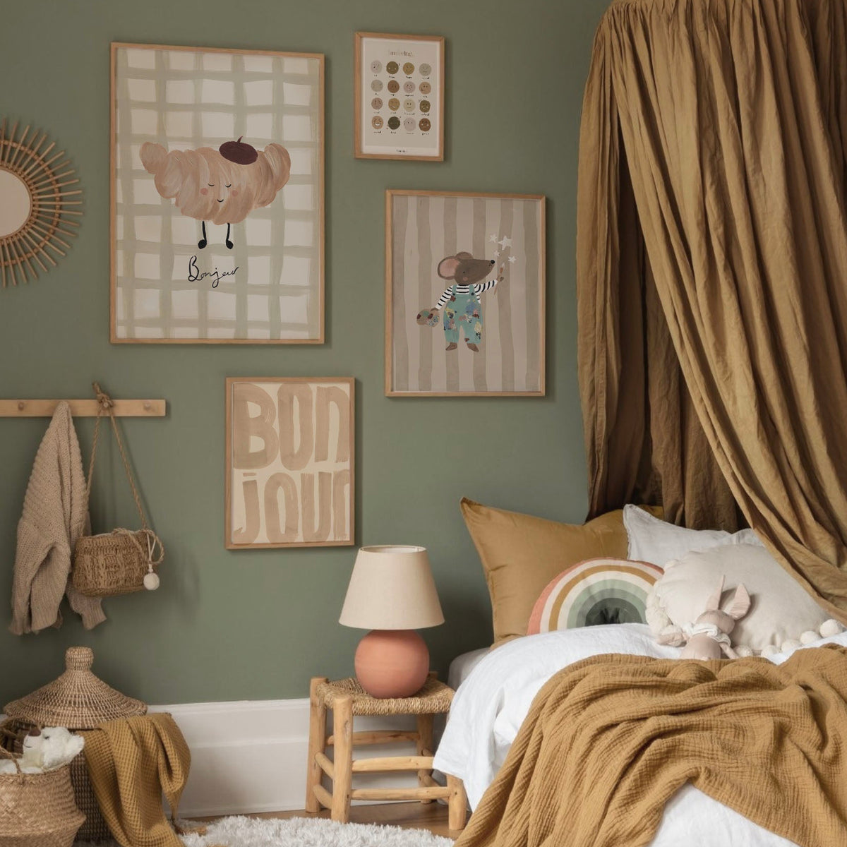 Children's bedroom with green walls, framed artwork, and a bed with brown bedding.
