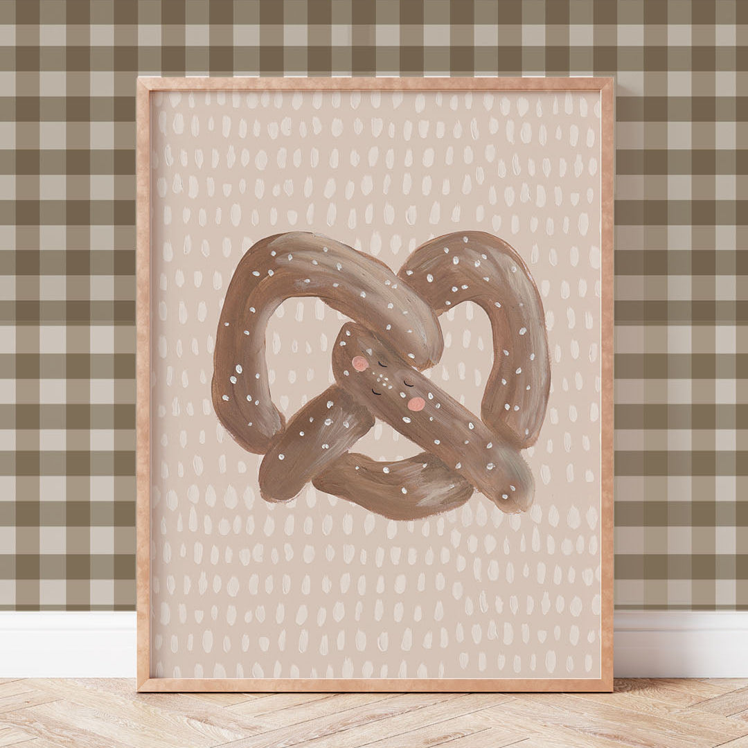 Framed artwork of a pretzel on a wall with a checkered pattern