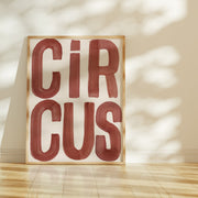 Framed artwork with 'CIRCUIS' text on a beige wall.