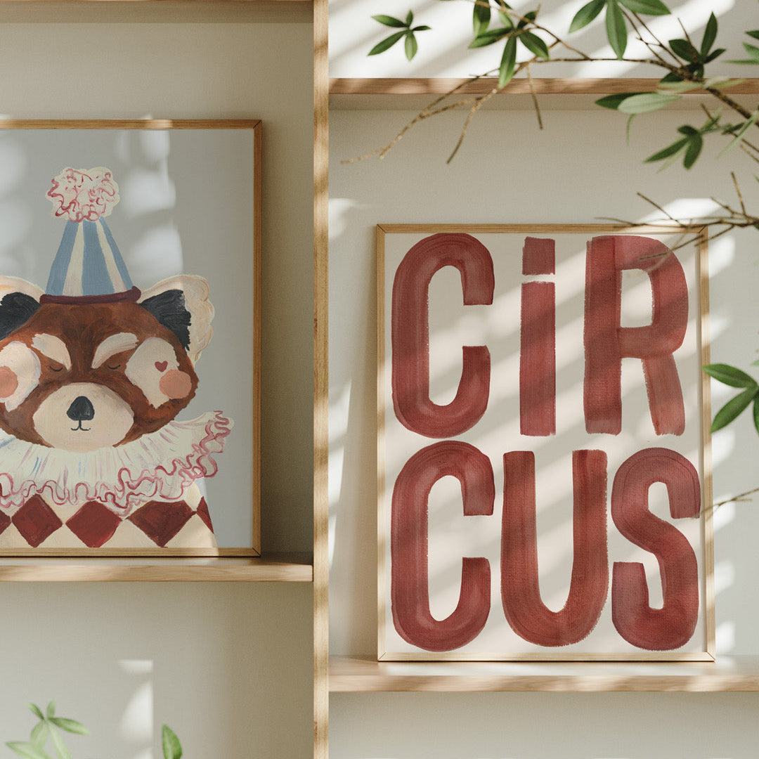 Framed artwork of a bear and 'Circus' text on a wall with plants.