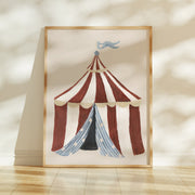 Framed artwork of a circus tent with a striped design on a beige wall.