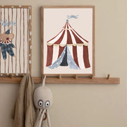 Children's room with framed circus-themed artwork and plush octopus toy on a wooden shelf.
