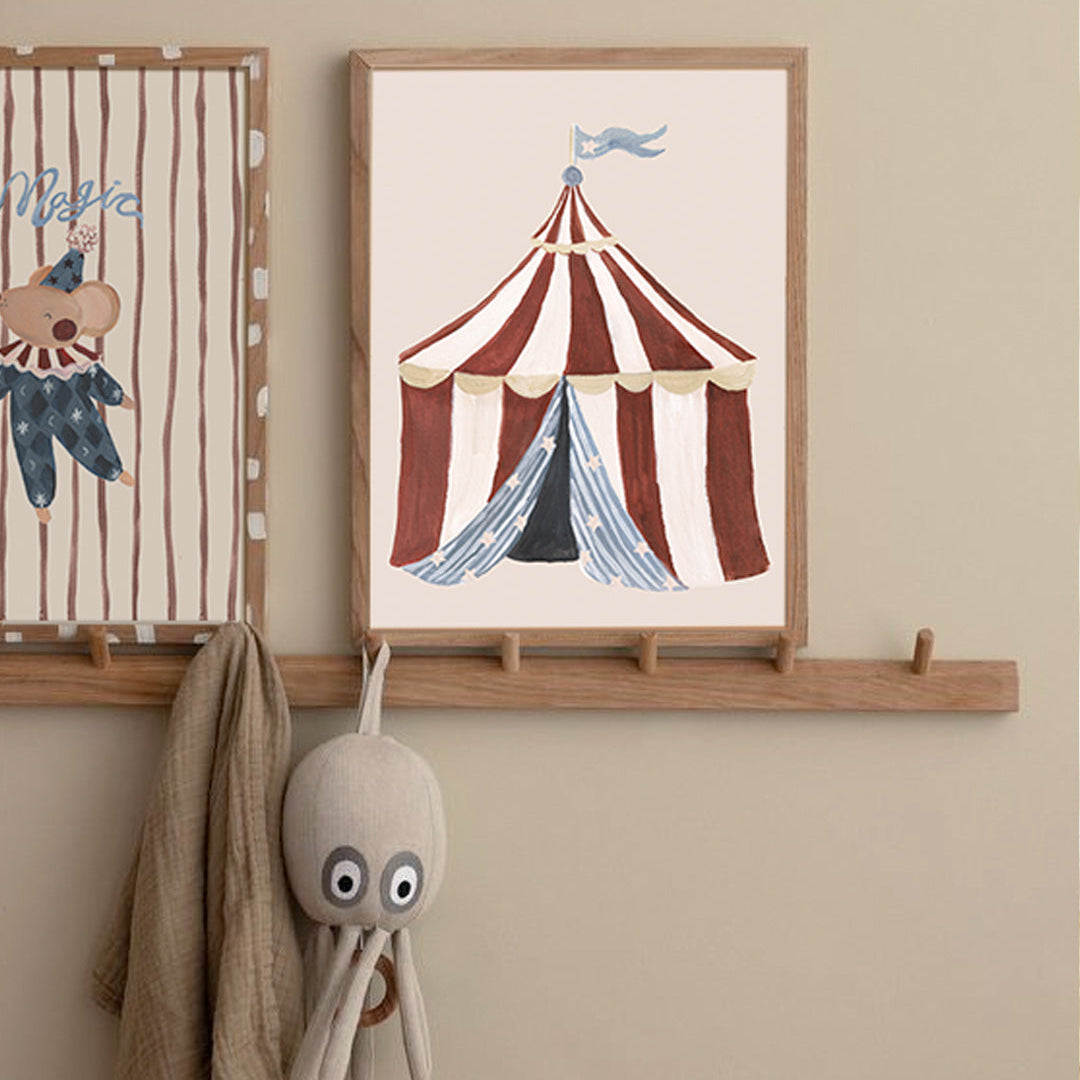 Children's room with framed circus-themed artwork and plush octopus toy on a wooden shelf.