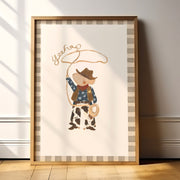 Framed artwork of a mouse cowboy holding a lasso on a striped background