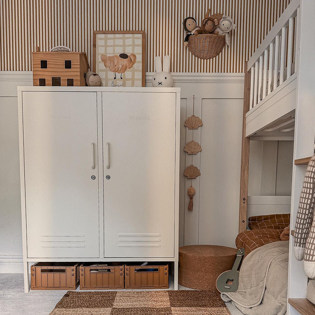 Children's room with a white cabinet, toys, and a bed.